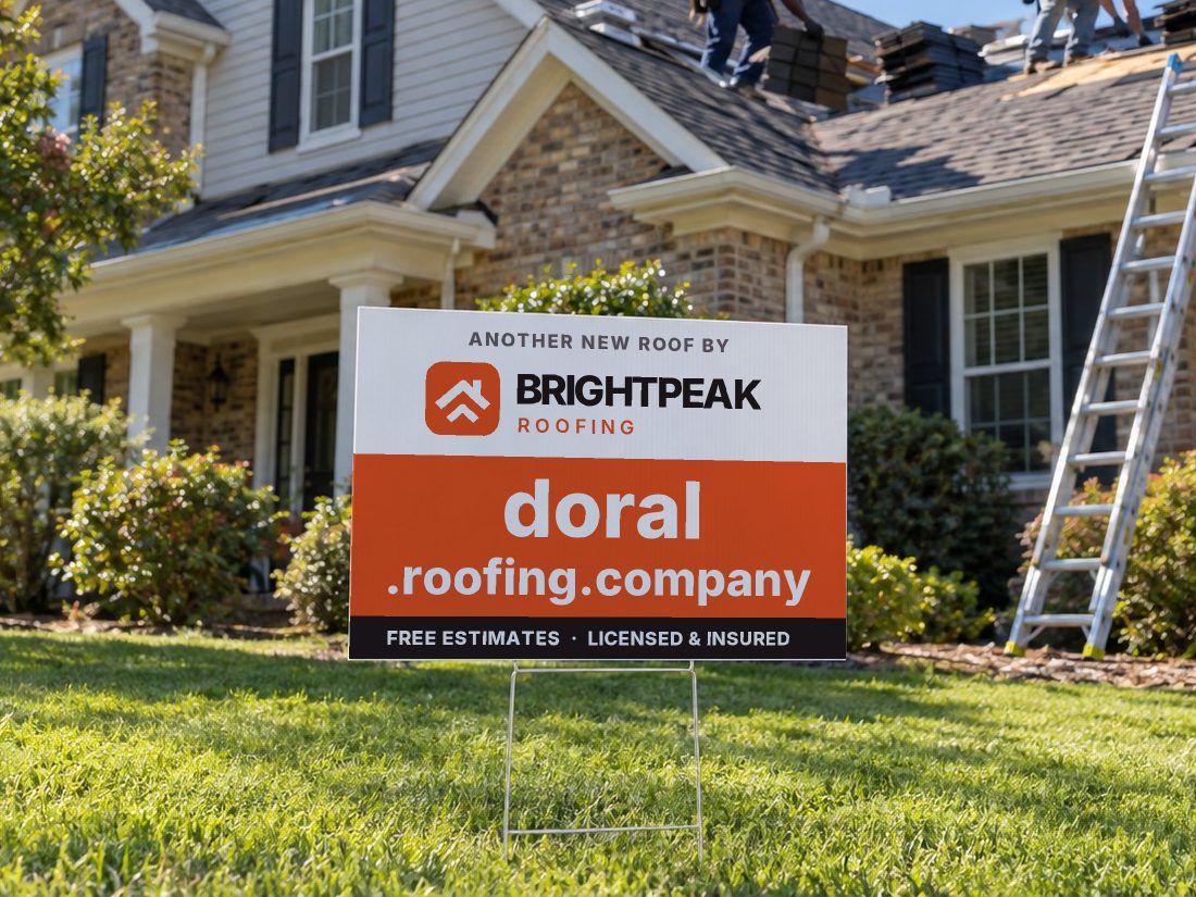 doral.roofing.company on a yard sign in front of a house getting a new roof